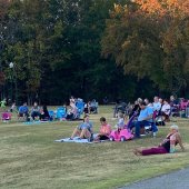 People sitting on blankets in the park