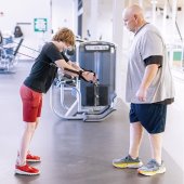A man and his son exercise in the weight room at Pelham Recreation Center.