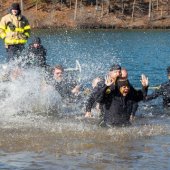 Law enforcement officers plunge into the icy waters of Double Oak Lake at Oak Mountain State Park.