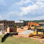 Heavy construction equipment moves dirt at City Park Central.