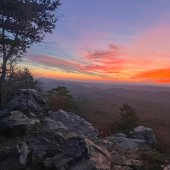 A colorful sunset over King's Chair lookout at Oak Mountain State Park.
