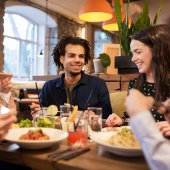 A group of friends share a meal in a restaurant.