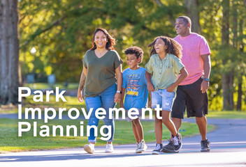 Family walking on greenway trail smiling