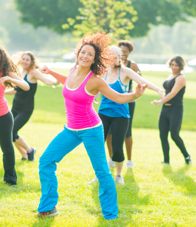 Salsa instructor in a park space with other dancers